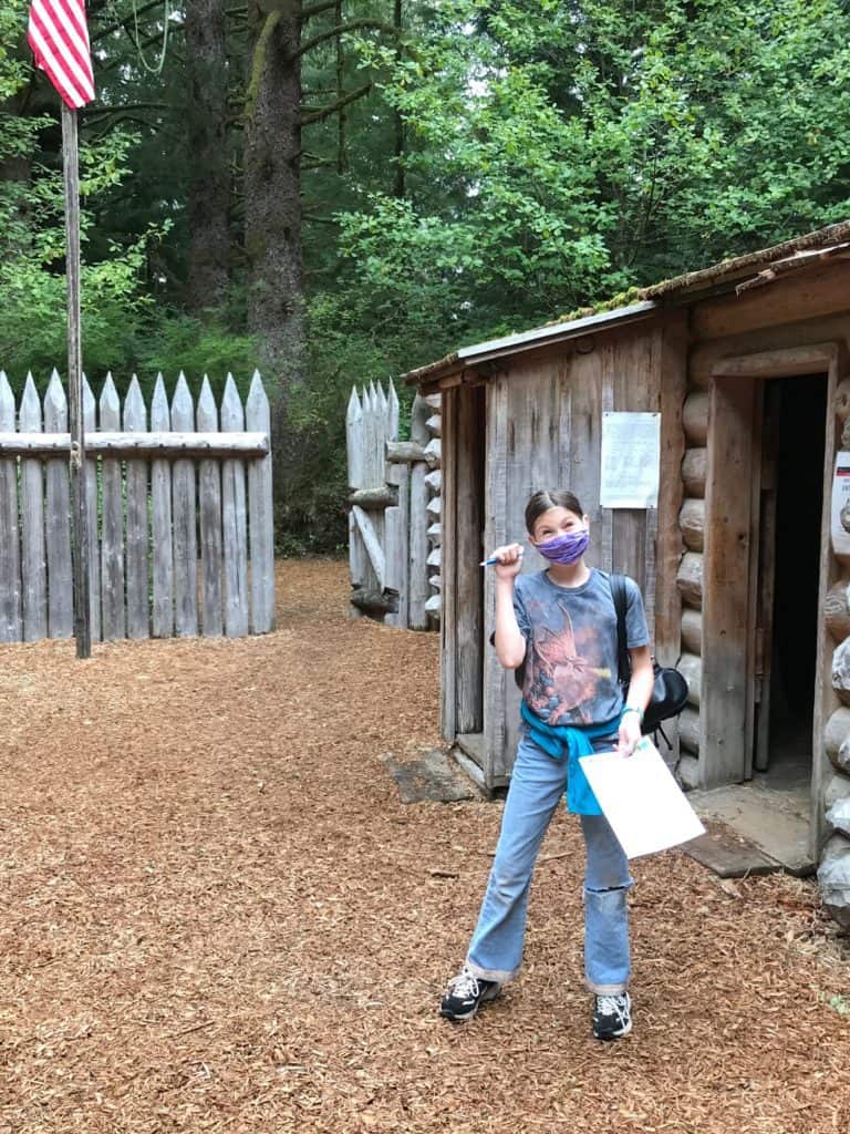 My daughter smiles as she explore Fort Clatsop at Lewis & Clark National Historical Park. Lewis & Clark NHP is one of the 19 best national parks in Oregon and Washington.
