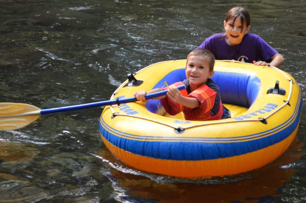 Girl pushing boy in inflatable raft. ADHD can occur in boys and girls, and can be diagnosed as young as age 5.