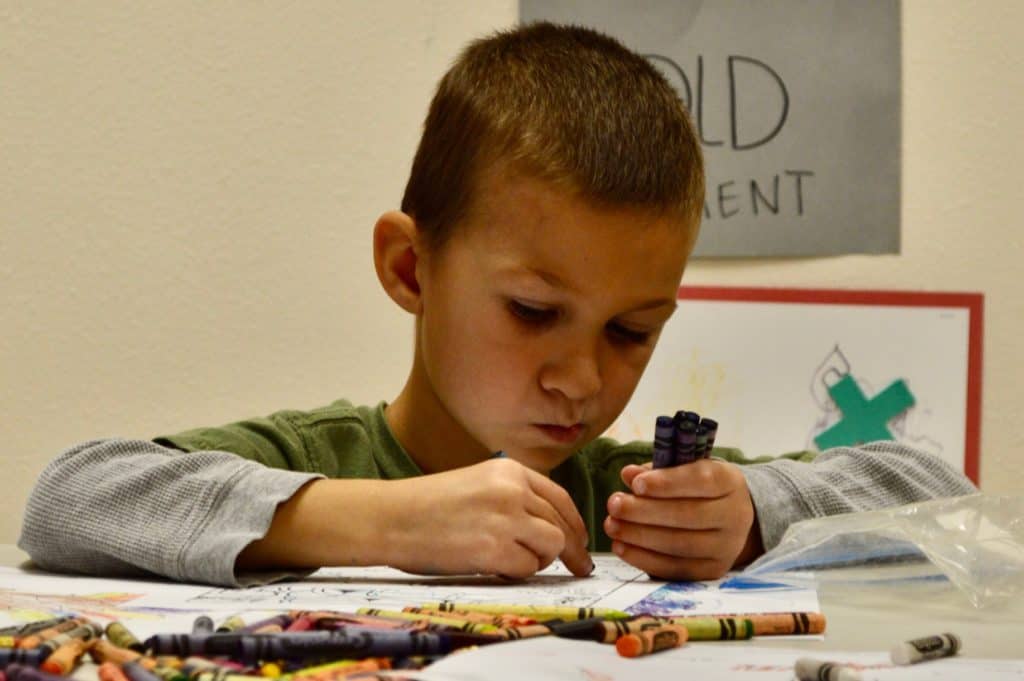 Boy using crayons.