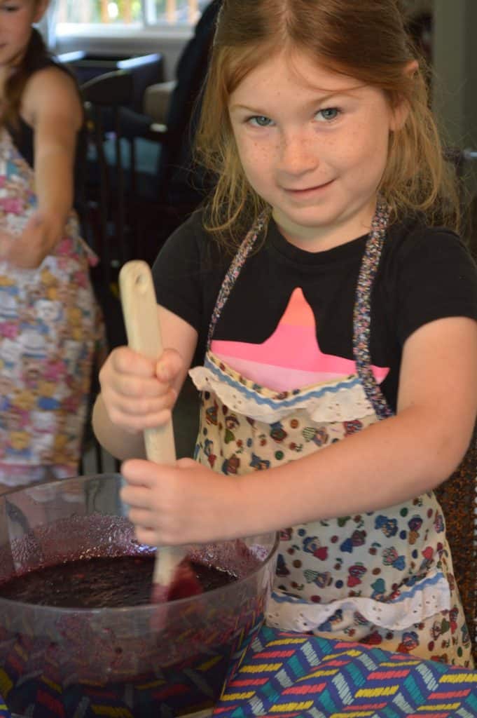 Girl in apron. Kids clothing organization ideas - you'll save money if your kids wear aprons for messy tasks.