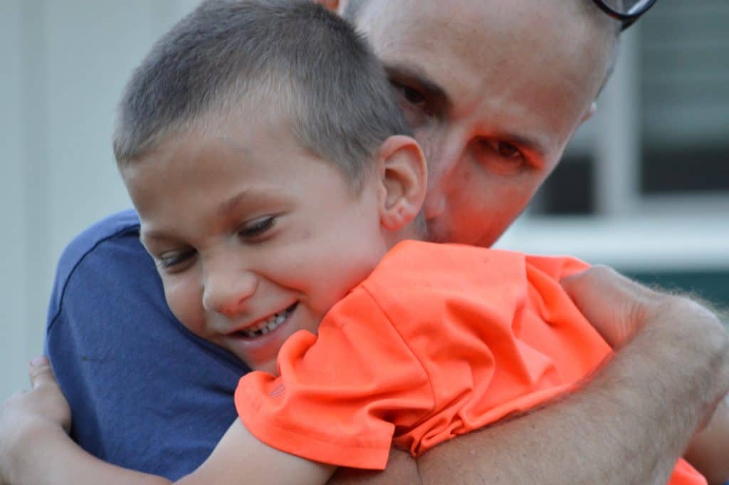 Father and son hugging.