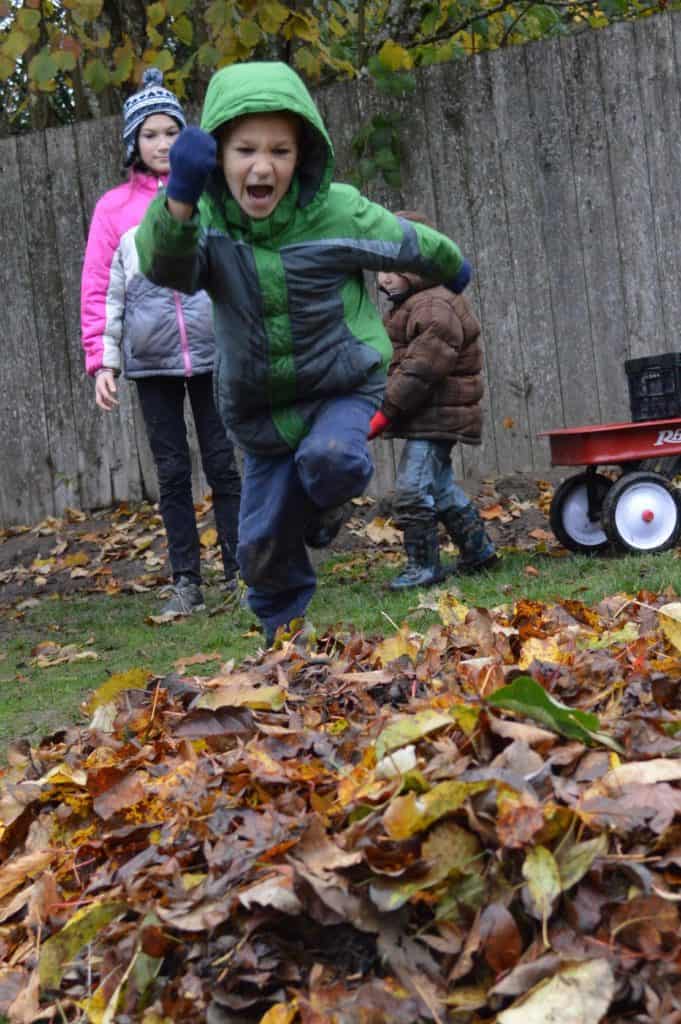 Boy running towards leaf pile. Hyperactivity is a hallmark sign of ADHD in children. This is a guide to who to talk to about ADHD.