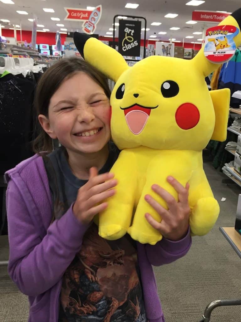 Girl holding a stuffed Pikachu. Who to talk to about ADHD.