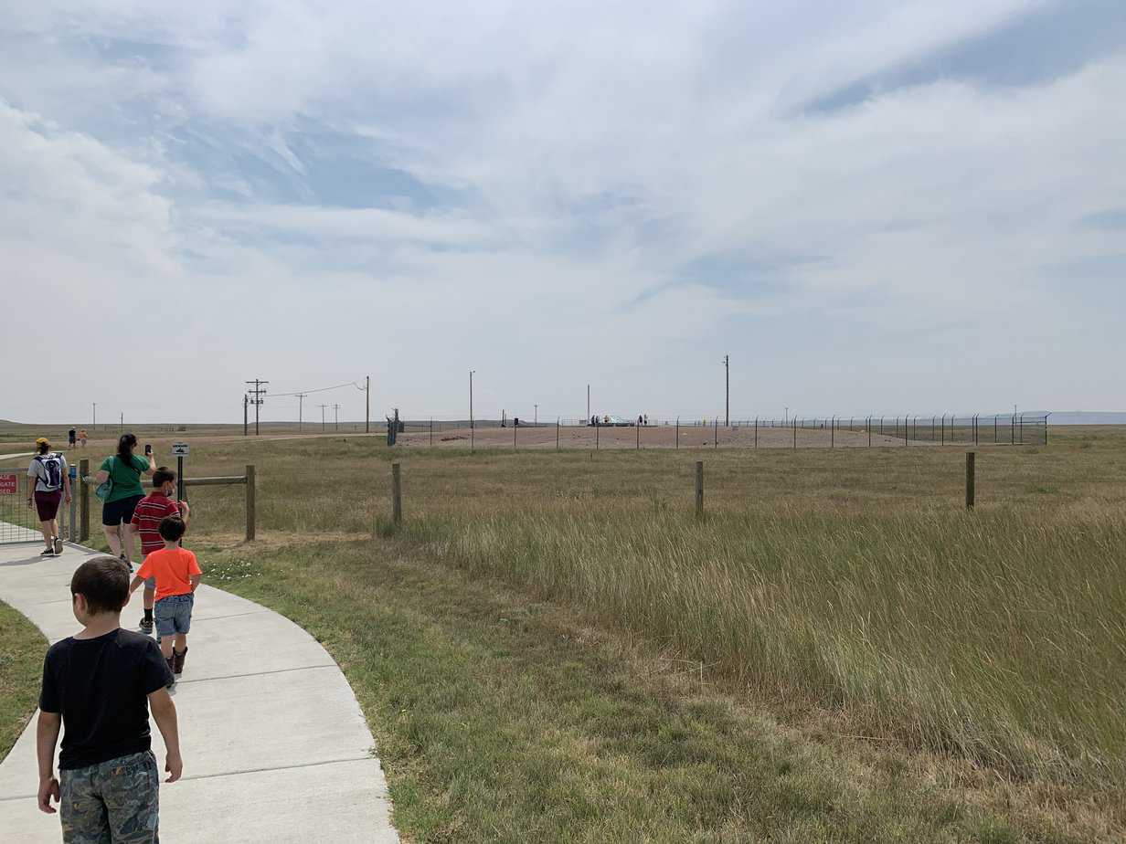 family walking towards the Missile silo  national park Delta-09 site.