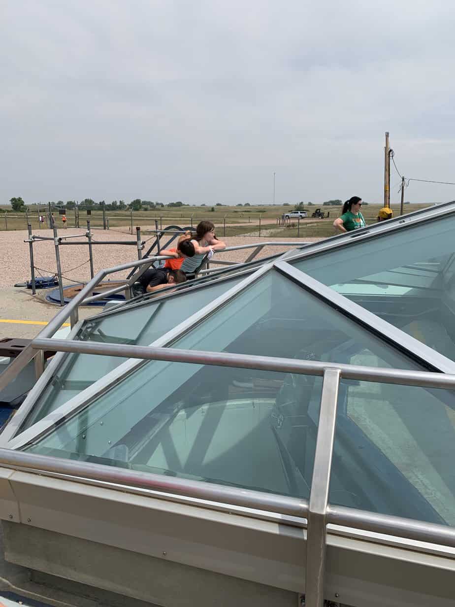 Our family peers though the glass roof into the missile silo housing a Minuteman Missile.