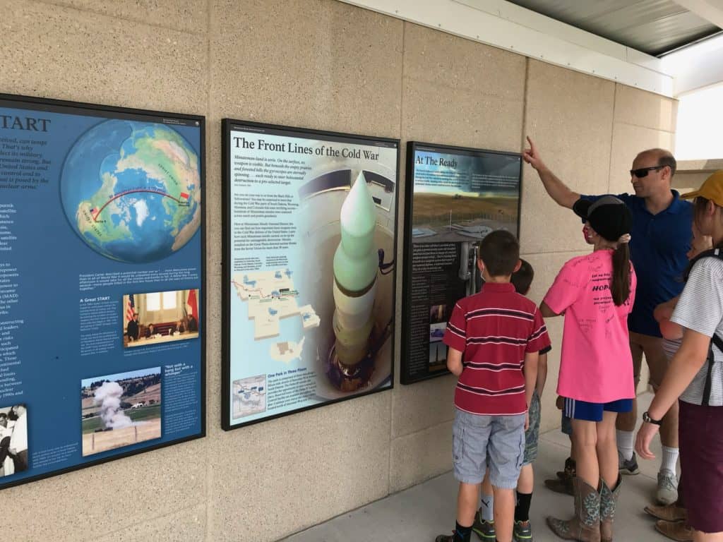 Me and my children look over a set of displays explaining the Delta-09 Missile Silo at Minuteman Missile NHS.