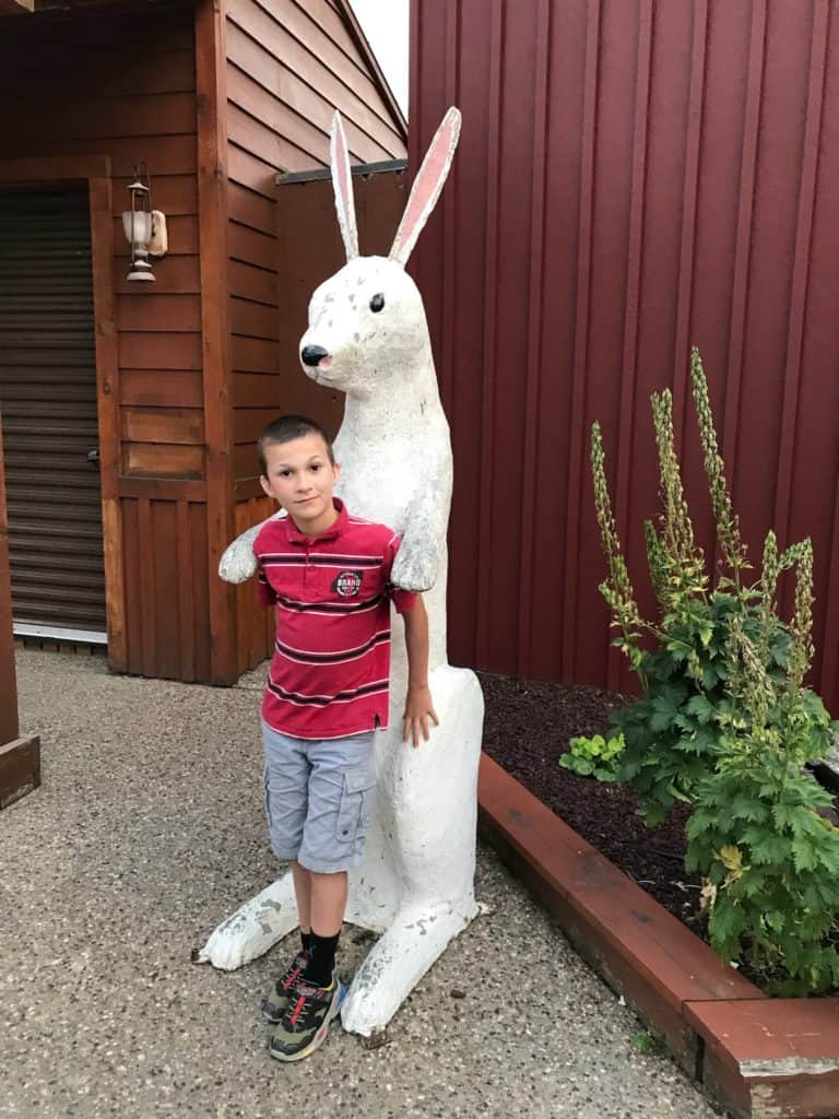 Boy with giant rabbit at Wall Drug.