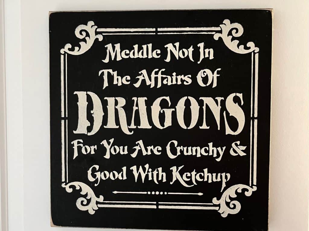 Sign says "Meddle not in the affairs of dragons for you are crunchy and good with ketchup." Dragon gifts for her.
