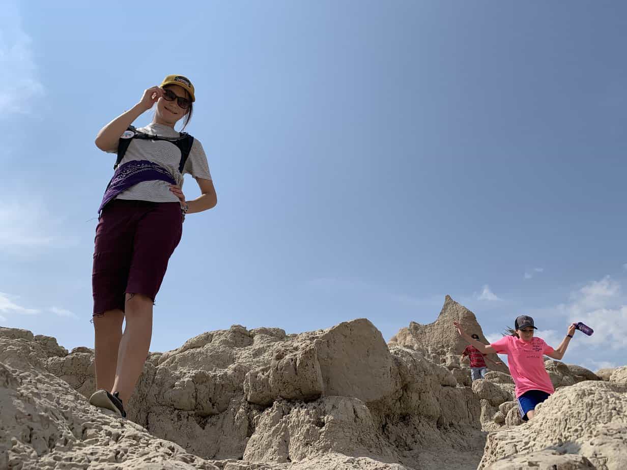 Girls climbing rocks in Badlands NP.