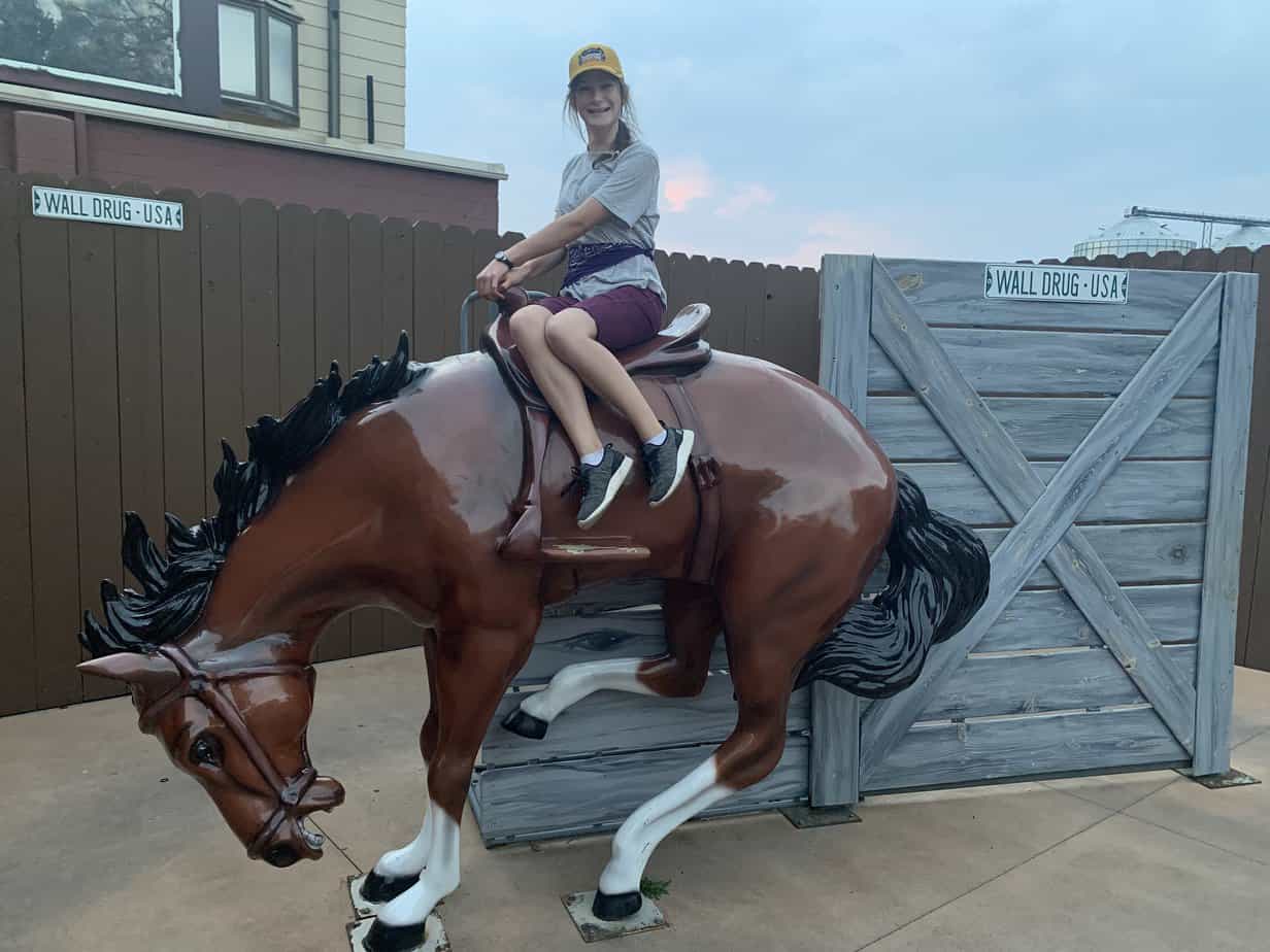 Girl sitting primly on bucking bronco. Rook didn't quite understand the "Bucking Bronco" concept.