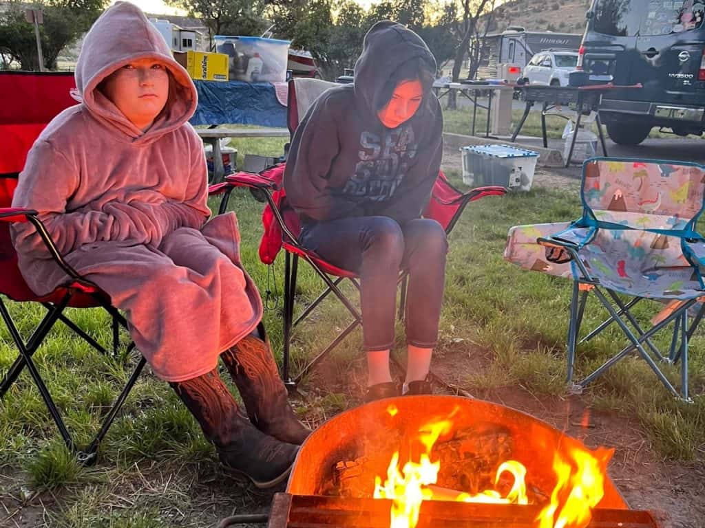 Girls by campfire. Camping ideas for families.