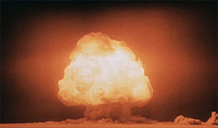 An image of the first nuclear test, a large mushroom cloud rises from New Mexico in 1945.