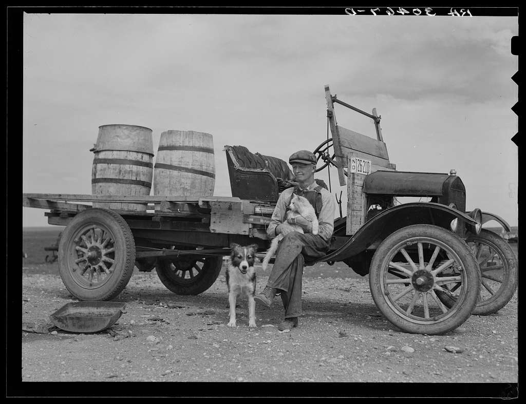 B& W photo of man with dog and cat. Wall Drug started up in the hardest of times. Image is public domain.