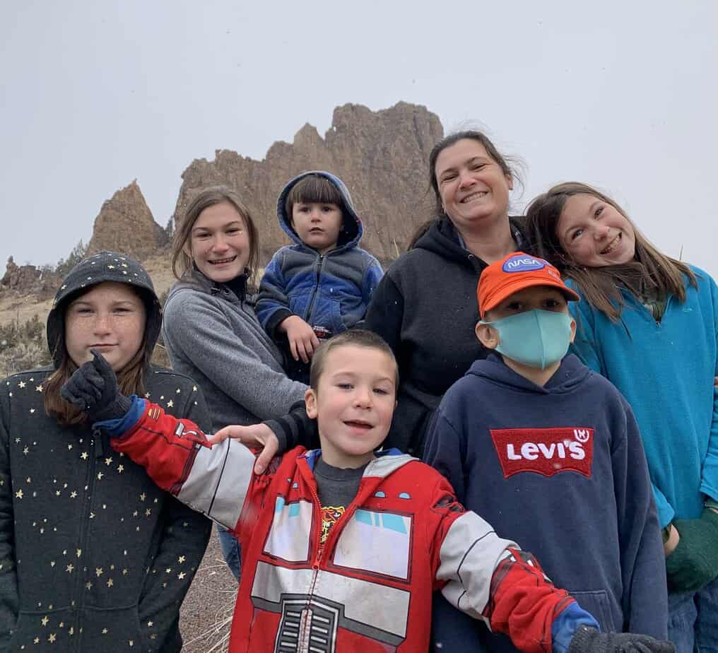 My wife and children smile in front of an enormous rock formation. We were ending a fun day of rock hunting in Eastern Oregon.