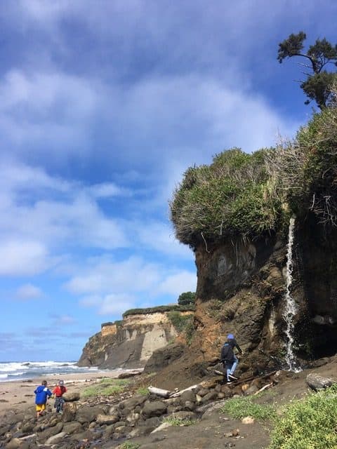 My children play by a water fall at a beautiful beach near Otter Rock, Oregon.