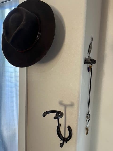 Horseshoe hat holders and a quail key holder grace our entryway. Cowboy gifts for men.