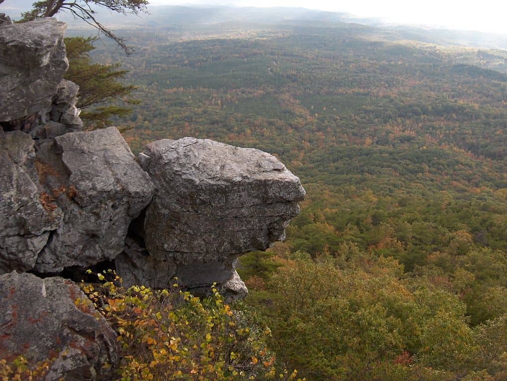 A granite outcropping towers above the rolling, wooded hills of the Southern Appalachians. Pinhoti Trail is one of the 17 best hiking trails in Birmingham AL.