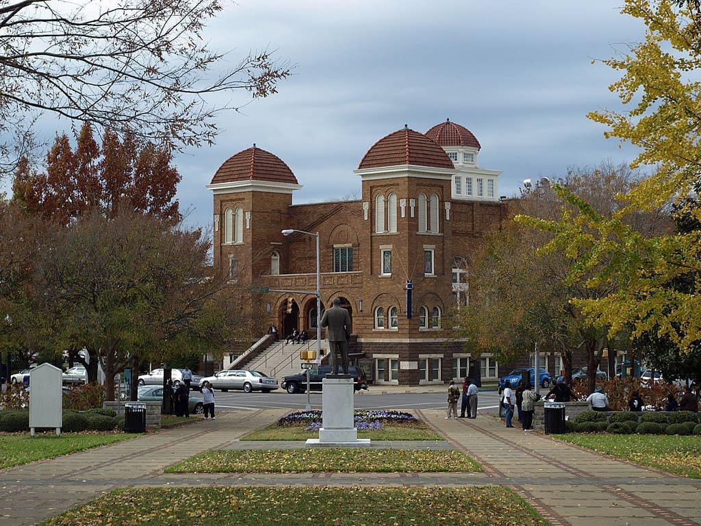 A bronze statue of Dr. Martin Luther King, Jr. stands in a square that faces Ebenezer Baptist Church. Martin Luther King, Jr. NHP is one of the 12 best national parks in Georgia.