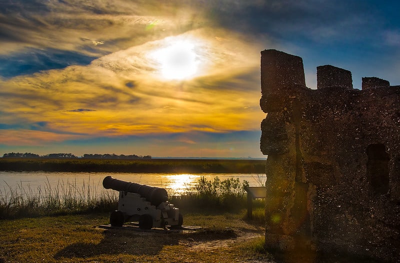 Historic battlements and a canon look over a peaceful lagoon at Fort Frederica National Monument. Fort Frederica is one of the 12 Best National Parks in Georgia.