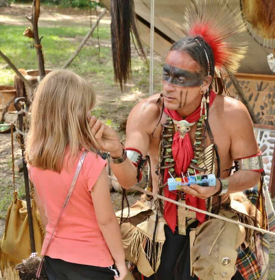 A native warrior applies ceremonial paint to a visiting student. Ocmulgee Mounds NHP is one of the 12 Best National Parks in Georgia.