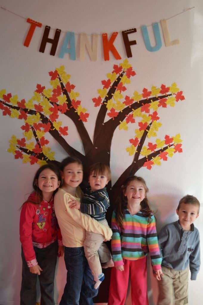 Thankful tree with 5 kids in front.