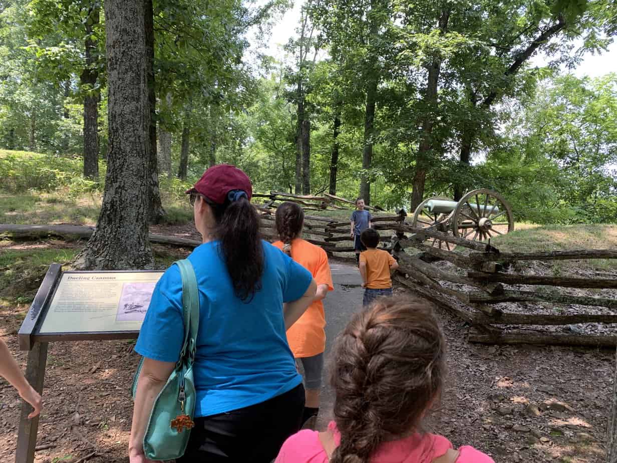 My wife and children read an interpretive sign and walk past Civil War canon placed on the summit of Kennesaw Mountain. 