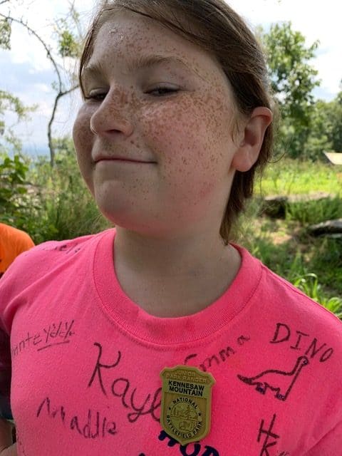 Our daughter proudly displays a Jr. Ranger badge that she earned while visiting Kennesaw Mountain National Battlefield Park. 
