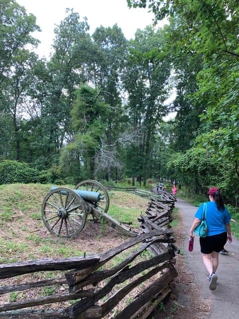 My wife walks past a canon protected by earthworks at Kennesaw Mountain National Battlefield Park. Kennesaw Mountain NBP is one of the 12 Best National Park Sites in Georgia.