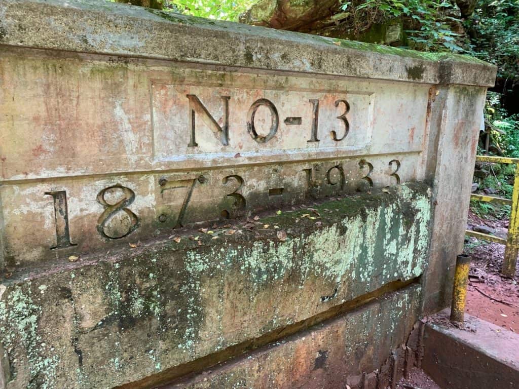 A historic cement mine entryway says "NO-13 1873-1933". Red Mountain Park's historic trails are some of the 17 best hiking trails Birmingham AL.