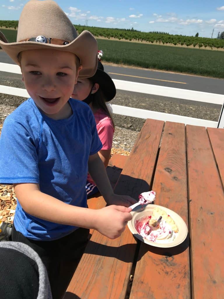 Boy in Cowboy hat eating marionberry pie, one of the best gifts from Oregon