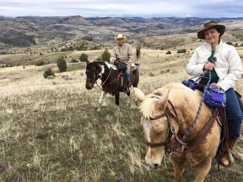 My wife and I stop for a picture. We're  each mounted on a horse and enjoying our ride among the foothills surrounding the town of Fossil, Oregon.