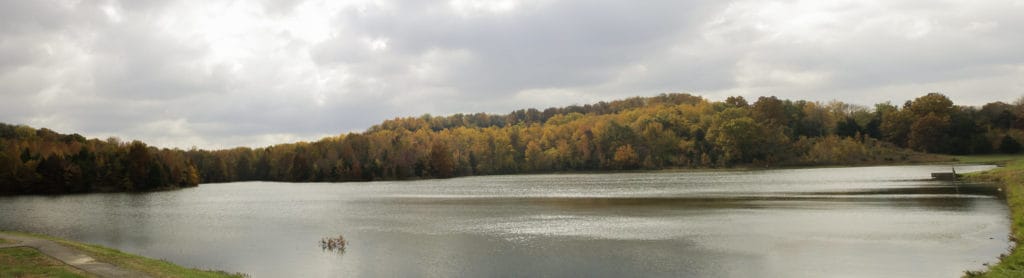 Autumn colors emblazon forestland around a lake at Ferne Clyffe State Park. 