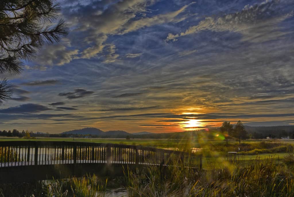The sun sets over the lovely grounds of the Sunriver resort in Sunriver Oregon. The cities of Central Oregon are one of the 15 best Portland Oregon day trips for families. 