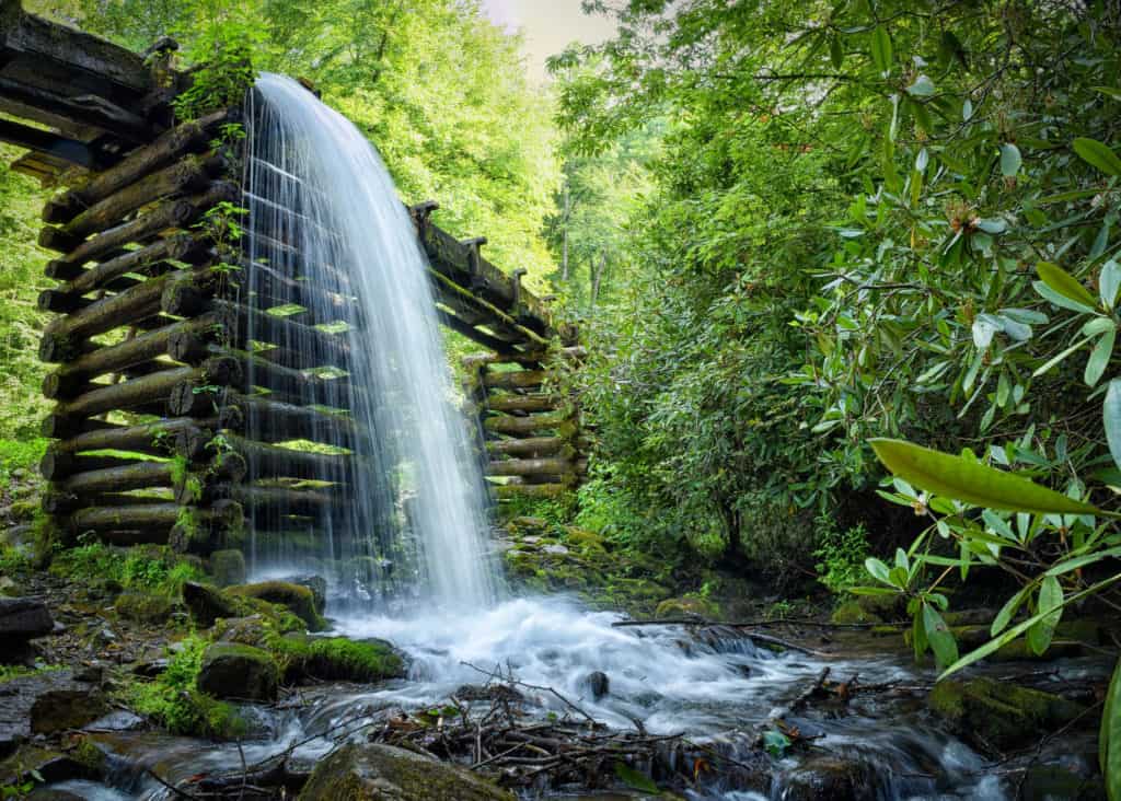 Water cascades from an old mill spillway amid forest greenery at Great Smoky Mountains National Park. Image from GPA Photo Archives.