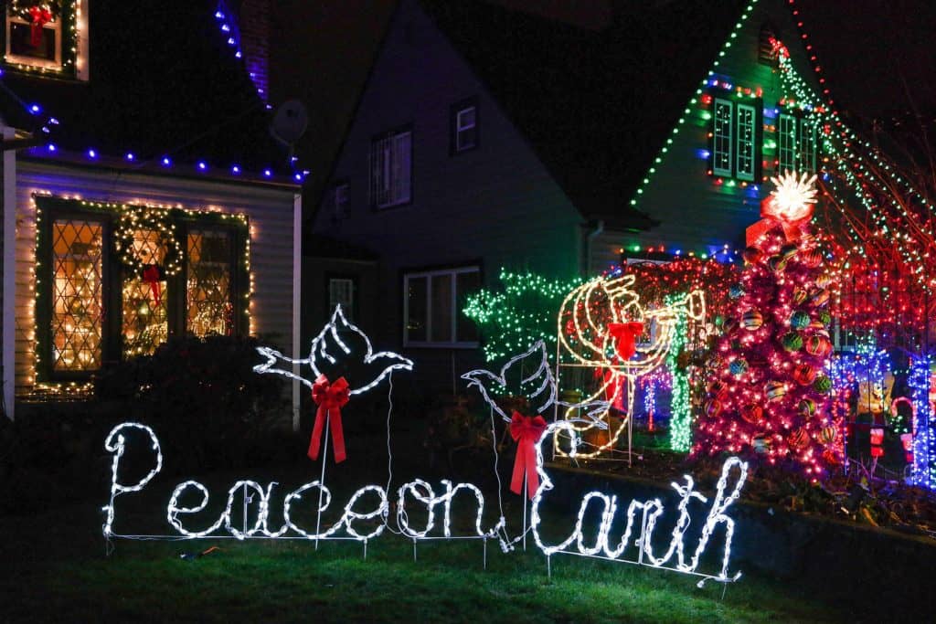 Lights and decor fill this picture of two homes on Portland's Peacock Lane. Peacock Lane is one of the 9 best places to see Christmas lights in Portland.