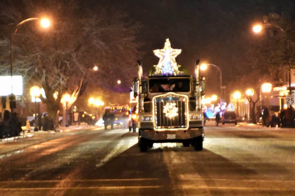 A decorated tractor trailer wears and enormous, bright Christmas star was it works its way down the Baker City Twilight Christmas Parade.