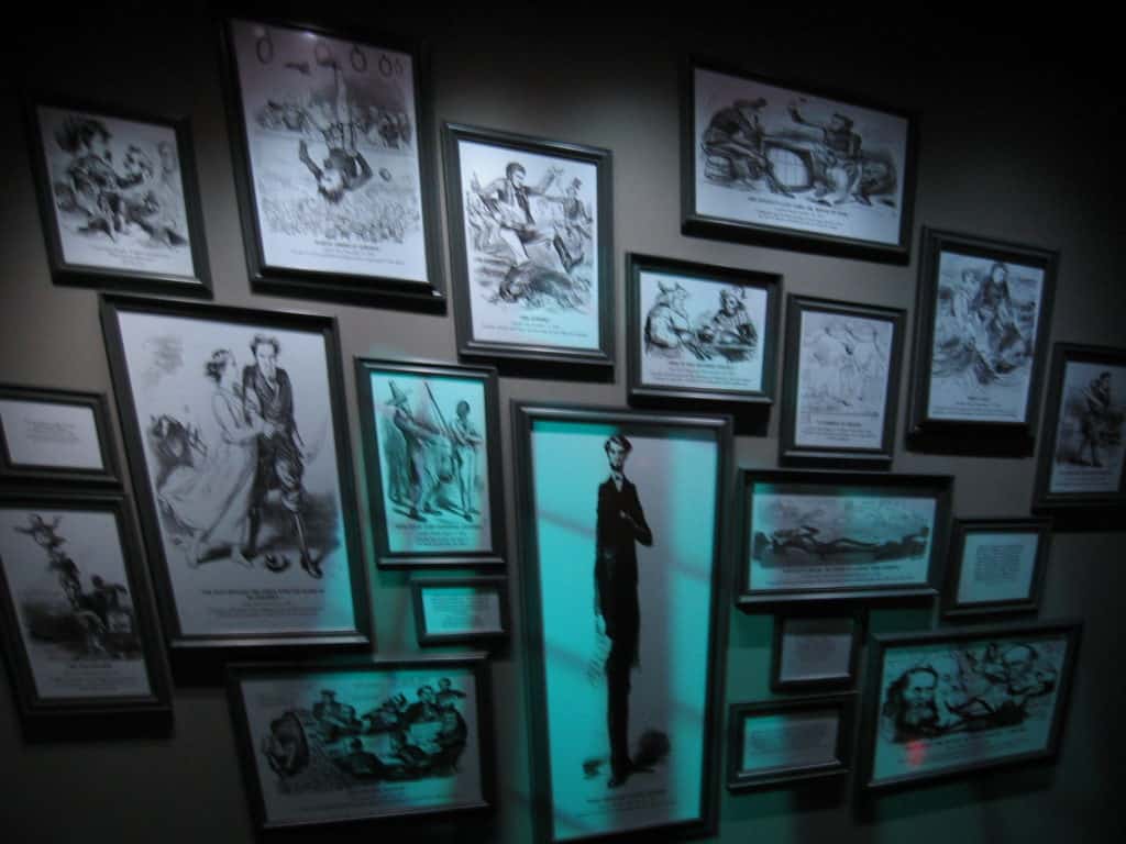 A dark hallway features a host of malicious political cartoons about Lincoln.