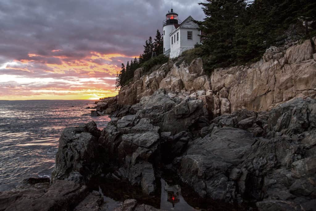A lighthouse stands watch at Acadia National Park. list of national parks and monuments by state