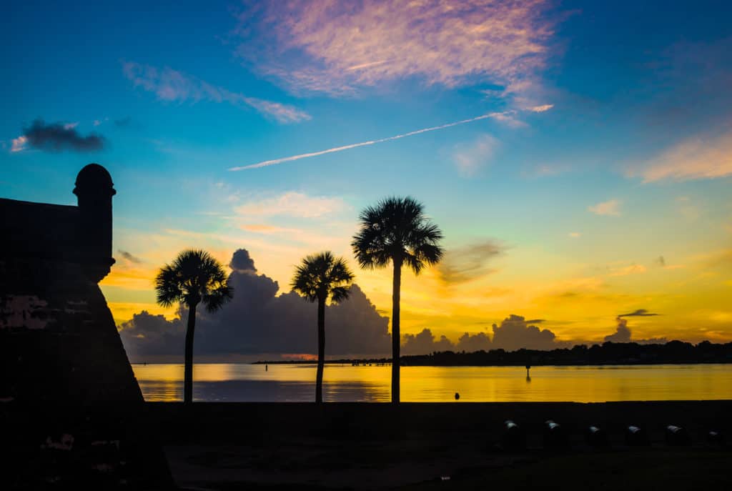 The sun rises over beautiful Castillo San Marcos National Monument in Florida. All of Florida's national parks can be found in order on Dinkum Tribe's List of National Parks and Monuments by State. Image by NPS.