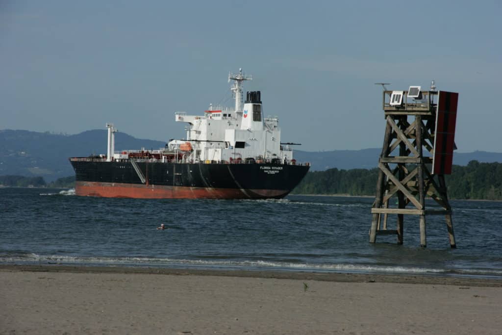 An enormous Tanker Boat cruises along the Columbia River beside Sauvie Island.