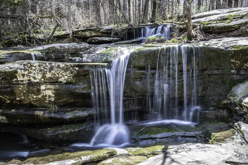 Water pours over sandstone rock formations in Illinois Shawnee Hills. 