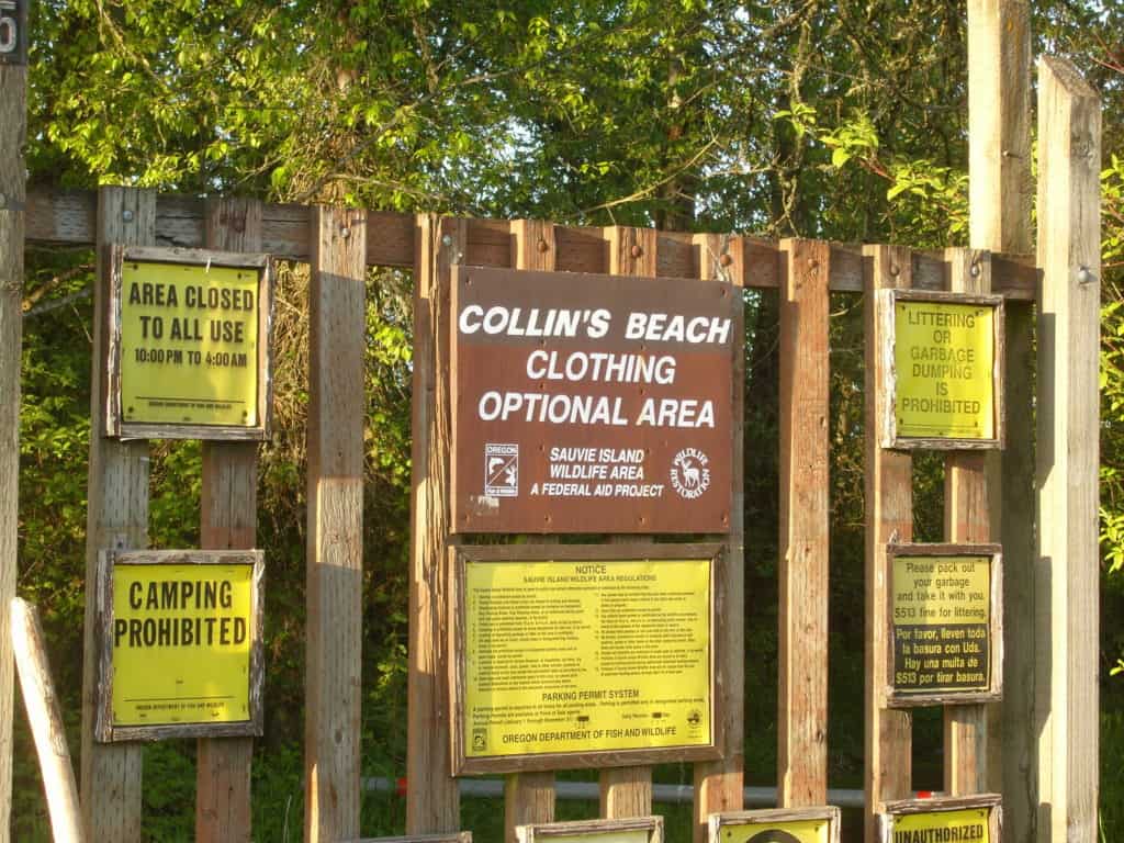 A posted sign says: "Collin's Beach, Clothing Optional Area."