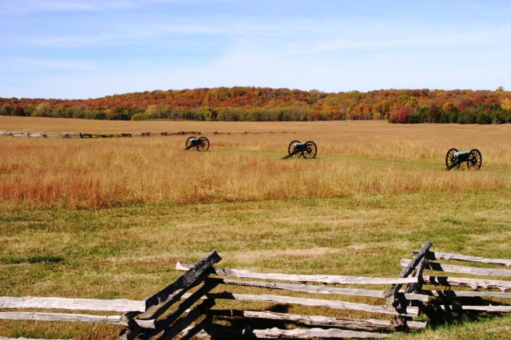 Canons stand silently in a mown field at Pea Ridge National Military Park. Image by NPS. list of national parks and monuments by state