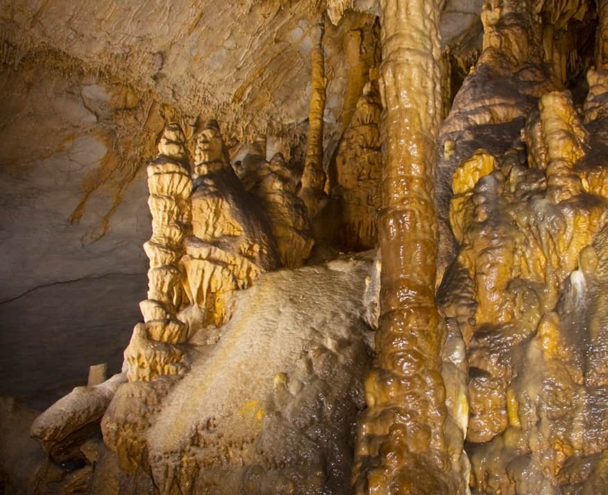 Strange limestone formations stand in Gap Cave at Cumberland Gap National Historical Park. You can find several limestone caves on Dinkum Tribe's list of national parks and monuments by state. Image from NPS.