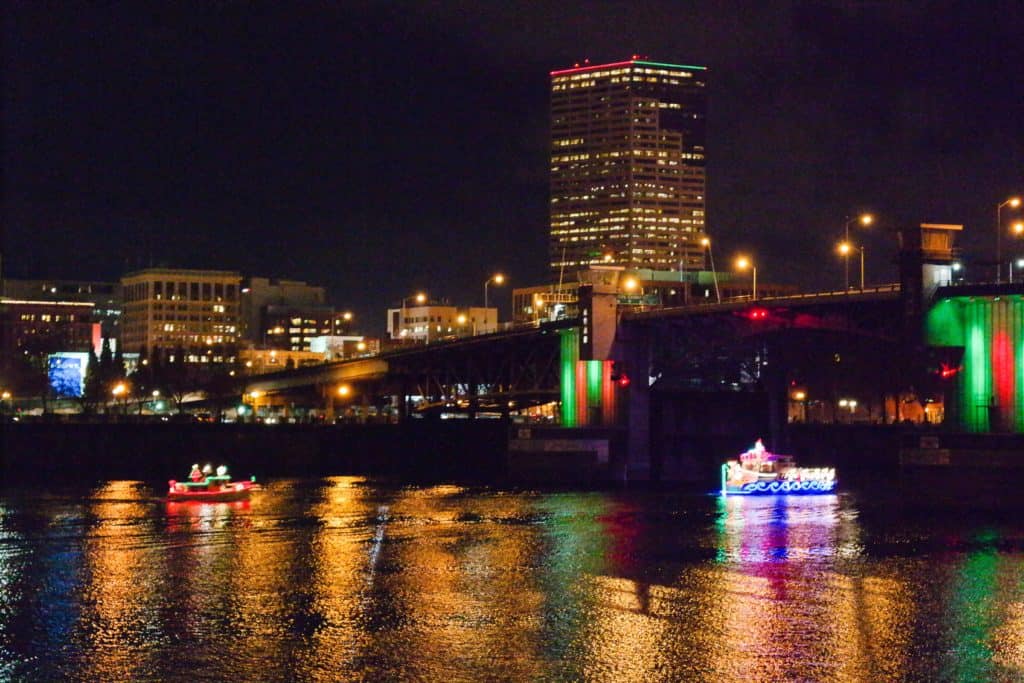 Brightly colored ships light up the Willamette River at Portland's Christmas Ship Parade. Best places to see Christmas lights in Portland, Oregon.