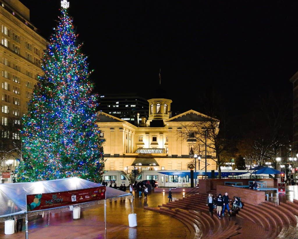 A grand Christmas tree towers over Pioneer Courthouse Square. Pioneer Courthouse Square is one of the best places to see Christmas lights in Portland.