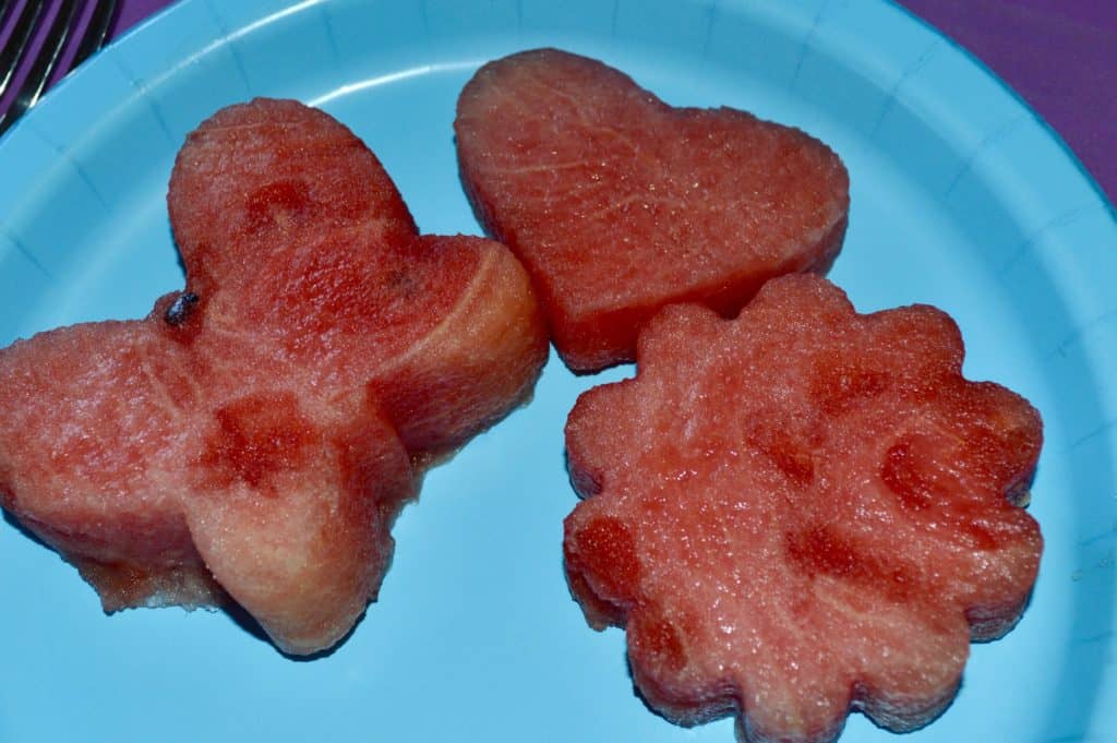 Watermelon cut into flower, butterfly and heart shapes. Valentine's Day picnic ideas.