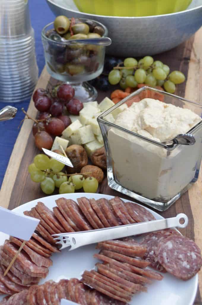 Charcuterie board with fruits, hummus, salami. Valentine's Day picnic ideas.