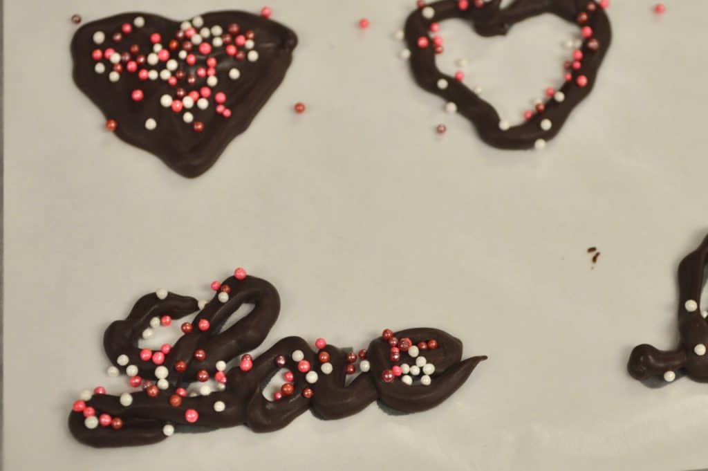 Dark chocolate shapes and script writing "Love".
