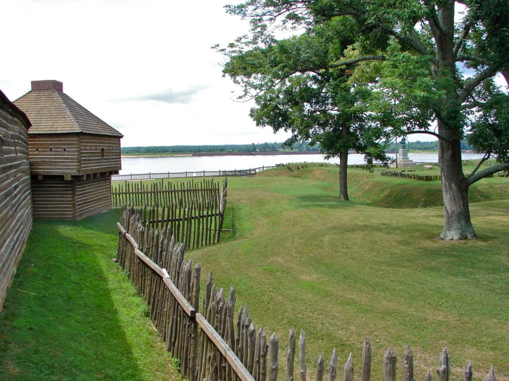 Reconstructed Fort Massac and a palisade fence stands beside the Ohio River. Fort Massac is one of the 37 best things to do in Southern Illinois.